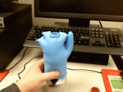 Person Holding Blue Glove GIF