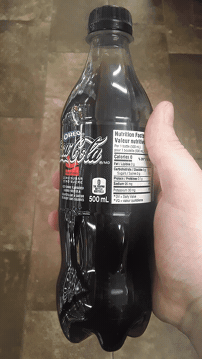 Person Holding Bottle Of Oreo Flavored Coke GIF