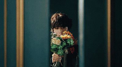Person Holding Bouquet Of Flowers In Front Of Mirror GIF