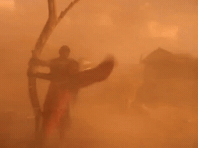 Person Holding Bow And Arrow In Desert GIF