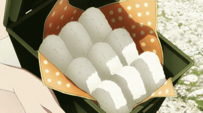 Person Holding Box Of Rice Balls On Polka Dot Cloth GIF