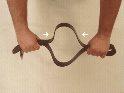Person Holding Brown Belt With Arrows GIF