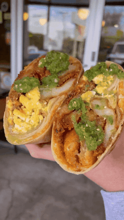 Person Holding Burrito With Eggs And Guacamole GIF
