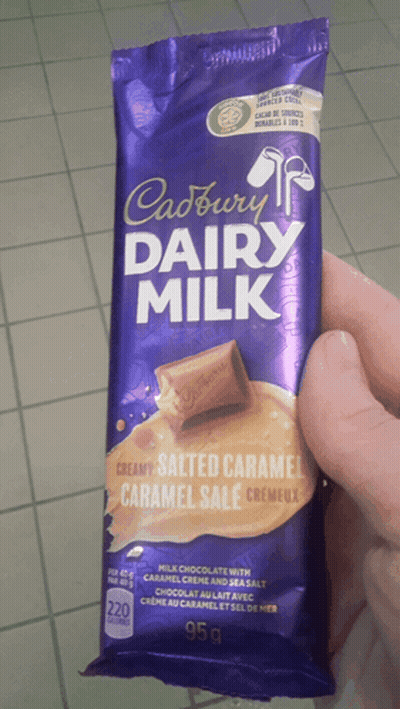 Person Holding Cadbury Dairy Milk Bar GIF