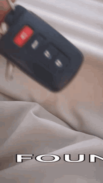 Person Holding Car Key In Front Of Four Logo GIF