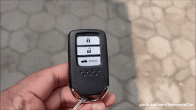 Person Holding Car Key With Hold Button GIF