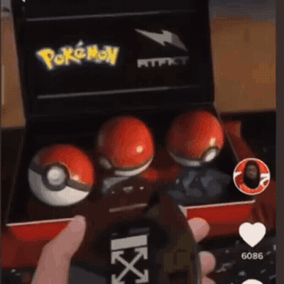 Person Holding Cell Phone And Pokemon Balls Box GIF