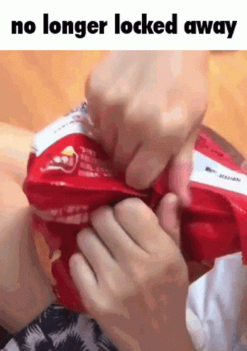 Person Holding Chips Saying No Longer Locked Away GIF