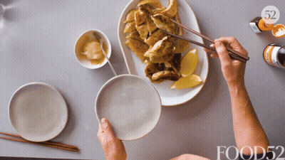 Person Holding Chopsticks Over Plate Of Food 52 GIF