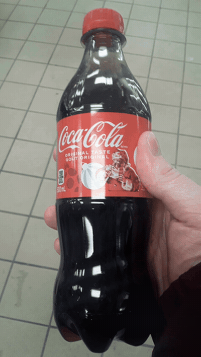 Person Holding Coca-Cola Bottle