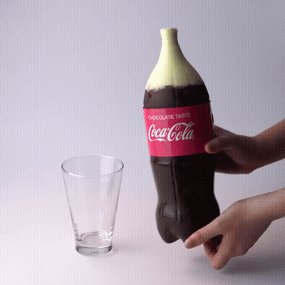 Person Holding Coca Cola Bottle With Chocolate Top GIF