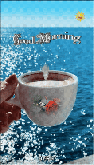 Person Holding Coffee In Front Of Ocean GIF