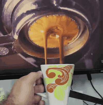 Person Holding Coffee In Front Of Samsung Screen GIF