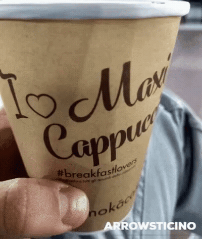 Person Holding Coffee In Front Of Samsung Screen GIF