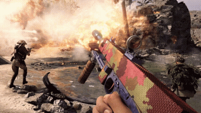 Person Holding Colorful Rifle in Front of Fire