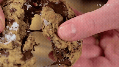 Person Holding Cookie With Insider Written GIF