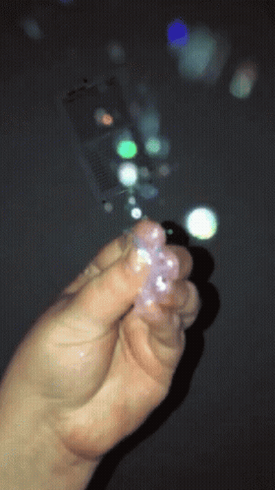 Person Holding Crystals With Bubbles GIF