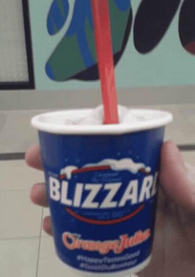 Person Holding Cup Of Blizzard Ice Cream GIF