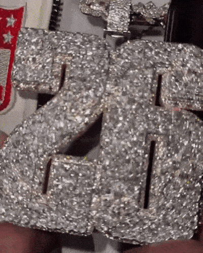 Person Holding Diamond Number 26 Necklace GIF