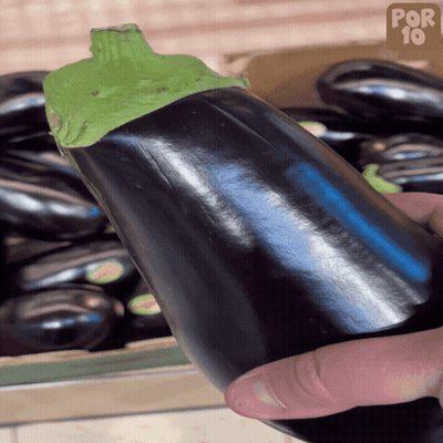 Person Holding Eggplant In Front Of Eggplant Box GIF