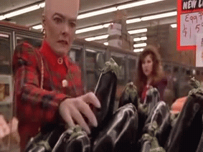 Person Holding Eggplant Over Red Bowl Of Water GIF