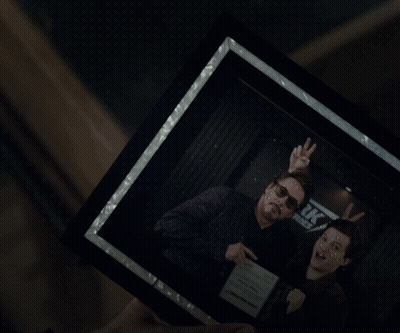 Person Holding Framed Picture Of Feet GIF