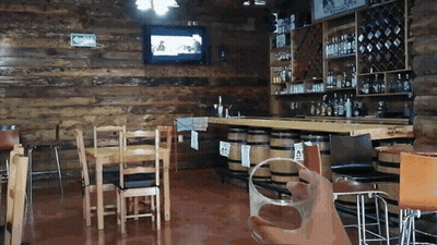 Person Holding Glass At Bar GIF