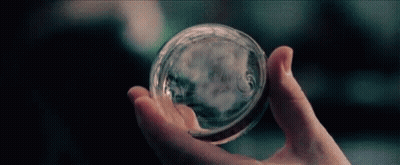 Person Holding Glass Sphere GIF