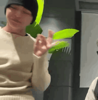 Person Holding Green Leaf In Beanie GIF