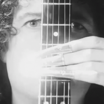 Person Holding Guitar In Black And White GIF