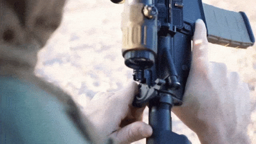 Person Holding Gun Close Up GIF