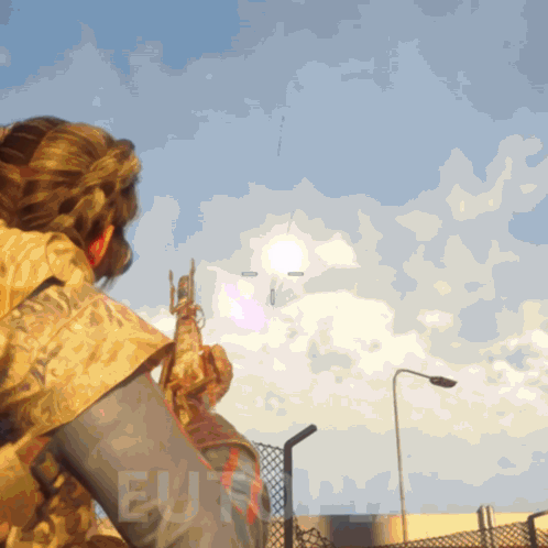 Person Holding Gun In Front Of Blue Sky Saying EU GIF