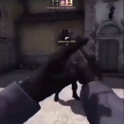Person Holding Gun In Front Of Building Playing On GIF