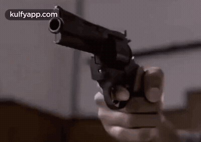 Person Holding Gun Pointing At Camera GIF