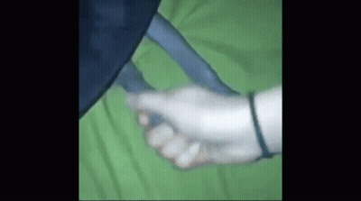 Person Holding Hand On Green Blanket GIF