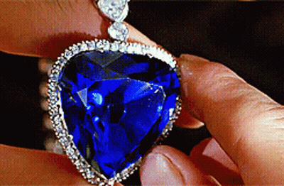 Person Holding Heart Shaped Sapphire Pendant GIF