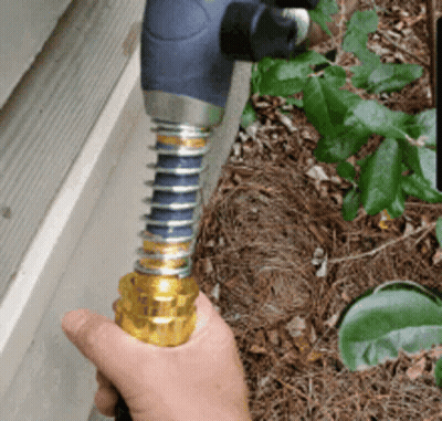 Person Holding Hose Near Wall GIF