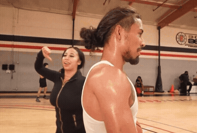 Person Holding Hot Dog In Front Of Food Tray GIF