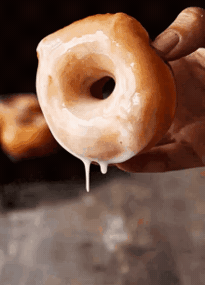 Person Holding Iced Donut GIF
