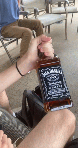 Person Holding Jack Daniel's Bottle GIF