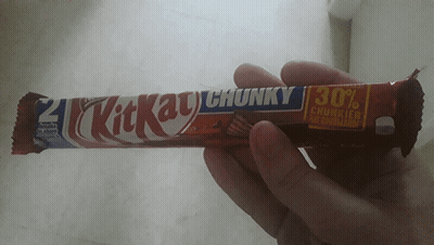 Person Holding KitKat Chunky Candy Bar GIF