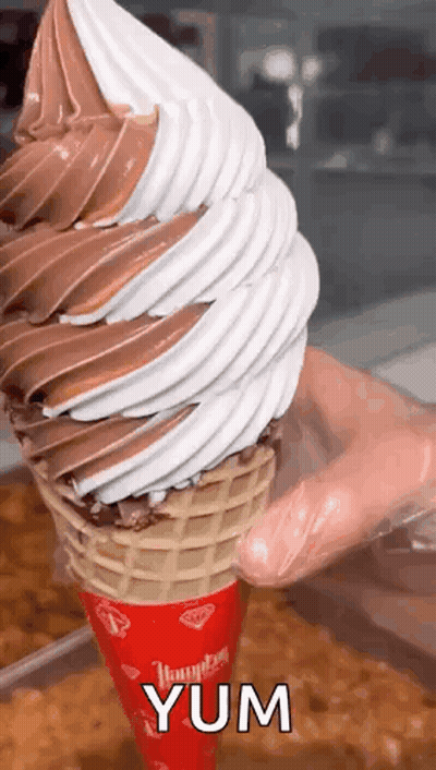 Person Holding Large Ice Cream Cone GIF