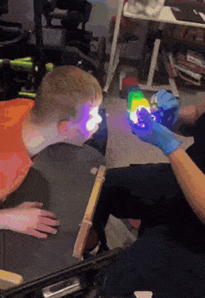 Person Holding Light Up Toy In Front Of Child GIF