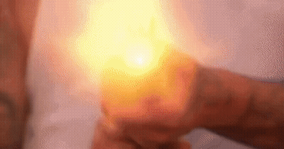 Person Holding Lit Candle GIF