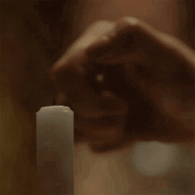 Person Holding Lit Candle GIF