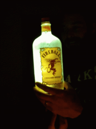 Person Holding Lit Fireball Whiskey GIF