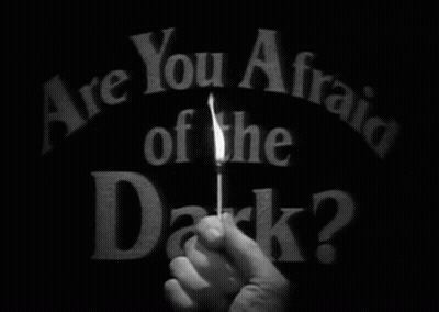 Person Holding Lit Match Saying Are You Afraid Of The Dark GIF