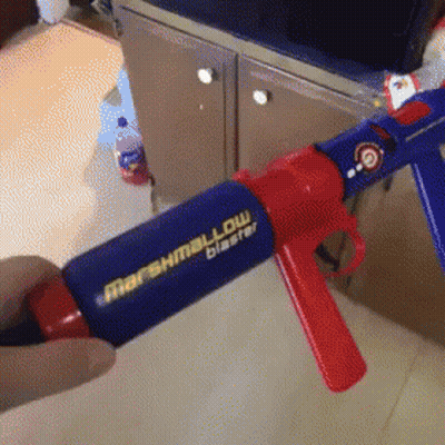 Person Holding Marshmallow Blaster Gun GIF