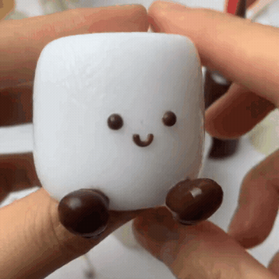 Person Holding Marshmallow With Face And Feet GIF