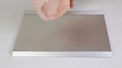Person Holding Meat on Metal Tray